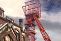 Red winding tower of the former Bonifacius colliery behind the facade of a hotel in a converted colliery building