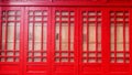 Red window brown wood wall.Detail of colorful window on old traditional house Royalty Free Stock Photo