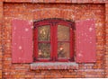 Red window on the facade of the old brick house.Christmas background, winter window, Christmas decoration. Royalty Free Stock Photo