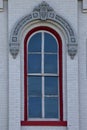 Red window on white brick wall