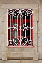 Red window with white styled iron grid