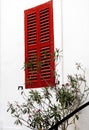 Red window on the white wall on Malta. Minimalizm