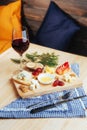 Red Wine And Assorted Cheese Plate with fruit.