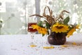 Red wine in a beautiful glass and a bouquet of sunflowers