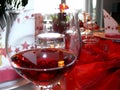 Beautifully decorated table with red wine glass in the foreground