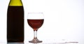 Red Wine being poured into Glass, against White Background Royalty Free Stock Photo