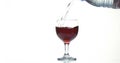 Red Wine being poured into Glass, against White Background Royalty Free Stock Photo