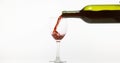 Red Wine being poured into Glass, against White Background Royalty Free Stock Photo