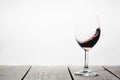 A red wine being poured into a glass on a white background Royalty Free Stock Photo