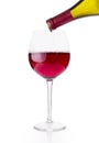 Red wine being poured into wine glass on white background Royalty Free Stock Photo