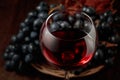 Red wine and blue grapes on an old wooden table Royalty Free Stock Photo