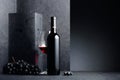 Red wine and blue grapeson a black stone table Royalty Free Stock Photo