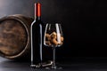 Red wine bottle, barrel and wine glass with corks Royalty Free Stock Photo