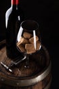 Red wine bottle, barrel and wine glass with corks Royalty Free Stock Photo