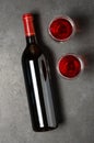 Red wine in a bottle. Black concrete background. Flat lay