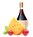 Red wine bottle, cheese and tomato still life Royalty Free Stock Photo