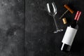 Red wine bottle with corkscrew, cork and wine glass on dark wooden table flat lay from above Royalty Free Stock Photo