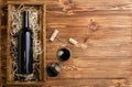 Red wine bottle corkscrew corks wine glasses on wooden table with copy space.Red Wine composition on brown wooden table. Top view