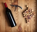 Red wine bottle, corkscrew and grape shaped corks Royalty Free Stock Photo