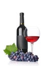 Red wine bottle with empty black label and glass for tasting with fresh grape Royalty Free Stock Photo