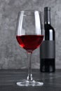 Red wine bottle with empty label and glass for tasting in cellar Royalty Free Stock Photo