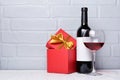 Red wine bottle with empty label, glass for tasting and gift box for romantic surprise Royalty Free Stock Photo