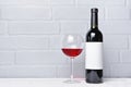 Red wine bottle with empty label and glass for tasting Royalty Free Stock Photo