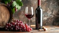 A red wine bottle with an empty surface, a wine glass, a wine barrel and grapes, set against a rustic backdrop Royalty Free Stock Photo