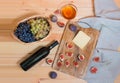 Red wine bottle, figs, cheese, bunches of grape and honey on wooden table Royalty Free Stock Photo