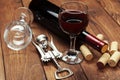 Red wine bottle, wine glass and corkscrew on wooden table background Royalty Free Stock Photo