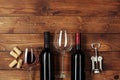 Red wine bottle, wine glass and corkscrew on wooden table background Royalty Free Stock Photo