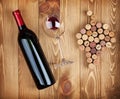 Red wine bottle, glass and grape shaped corks Royalty Free Stock Photo
