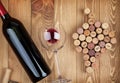 Red wine bottle glass and grape shaped corks Royalty Free Stock Photo