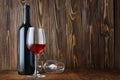 Red wine bottle and glass for tasting in cellar with copy space Royalty Free Stock Photo