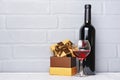 Red wine bottle, glass for tasting and gift box for romantic surprise Royalty Free Stock Photo