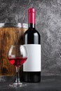 Red wine bottle with glass for tasting and wooden barrel in dark cellar Royalty Free Stock Photo