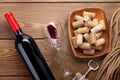 Red wine bottle, glass of wine, bowl with corks and corkscrew Royalty Free Stock Photo