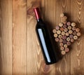 Red wine bottle and grape shaped corks Royalty Free Stock Photo