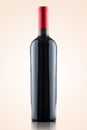 Red wine bottle with no label isolated over a warm gradient background