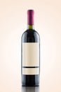 Red wine bottle isolated over a warm gradient background