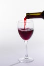 Red wine bottle pour glass on white background Royalty Free Stock Photo