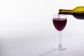 Red wine bottle pour glass on white background with copy space Royalty Free Stock Photo