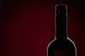 Red Wine bottle silhouette isolated on black background, red backlight, horizontal with copy space Royalty Free Stock Photo