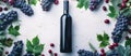 Red Wine Bottle Surrounded by Grapes and Leaves Royalty Free Stock Photo
