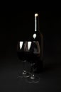 Red Wine. Bottle and Two Glasses of Red Wine on Black Background Royalty Free Stock Photo