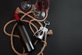 Red wine bottle, two glasses and corkscrew on black background. Top view with copy space Royalty Free Stock Photo