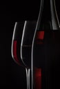 Red wine bottle and two wine glasses on black background Royalty Free Stock Photo