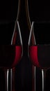 Red wine bottle and two wine glasses on black background Royalty Free Stock Photo