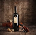 Red wine bottle and violin Royalty Free Stock Photo
