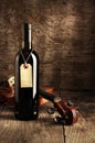 Red wine bottle and violin Royalty Free Stock Photo